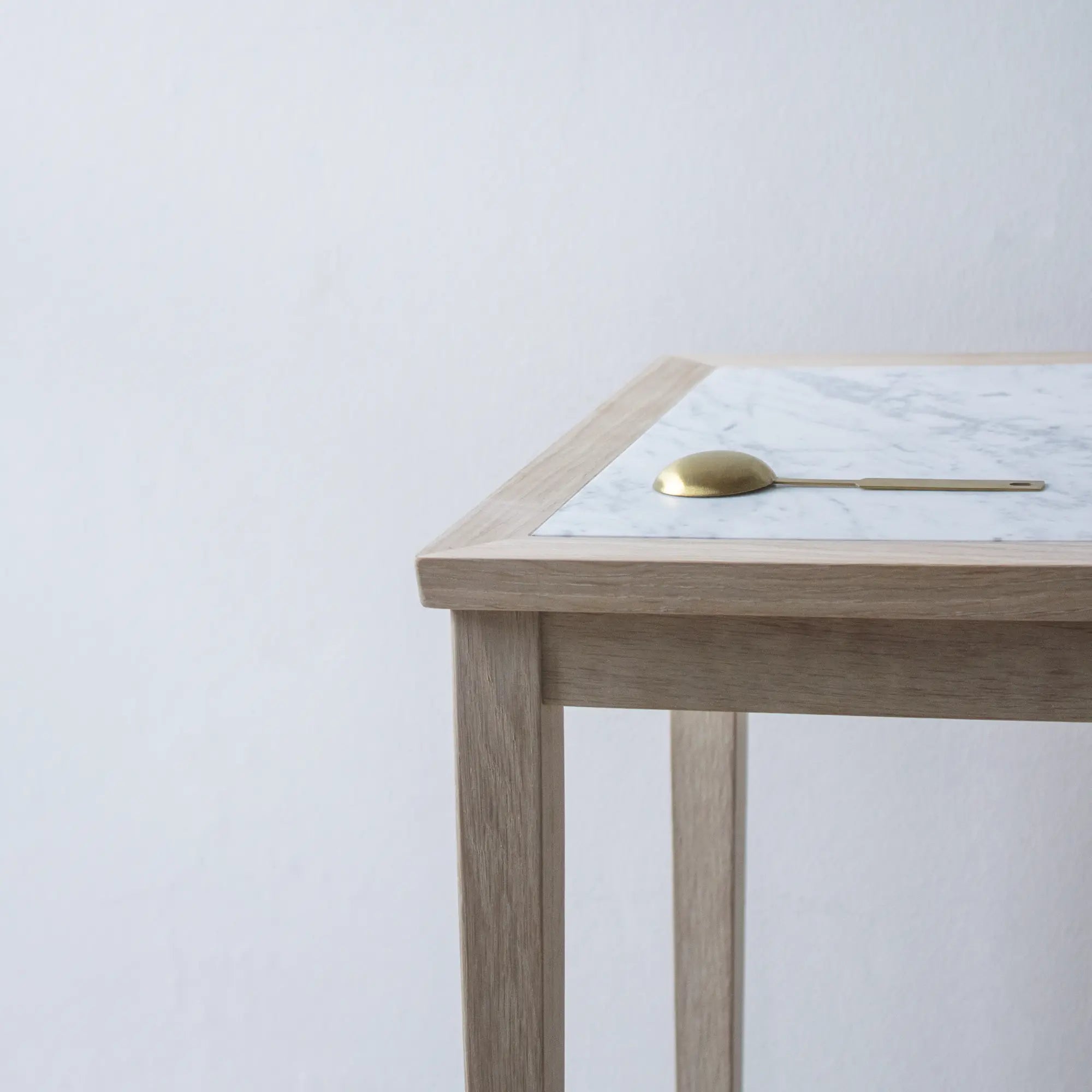 Minimalist No 1 Side Table with a round marble top and brass base