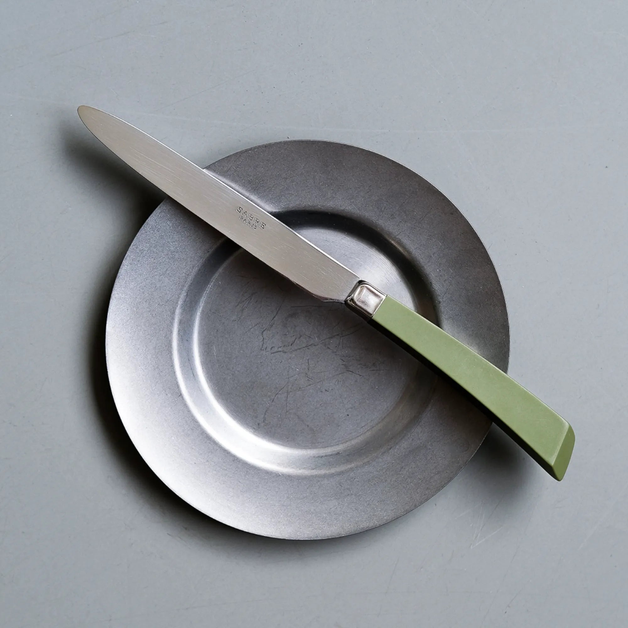 Stainless steel cutlery set with sleek design, including knives, forks, and spoons