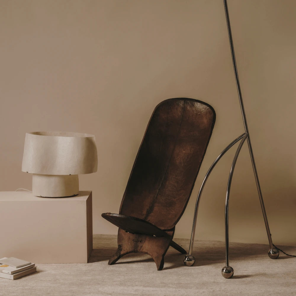 A side view of the Giraffe Lamp showcasing its sleek and stylish silhouette against a neutral backdrop