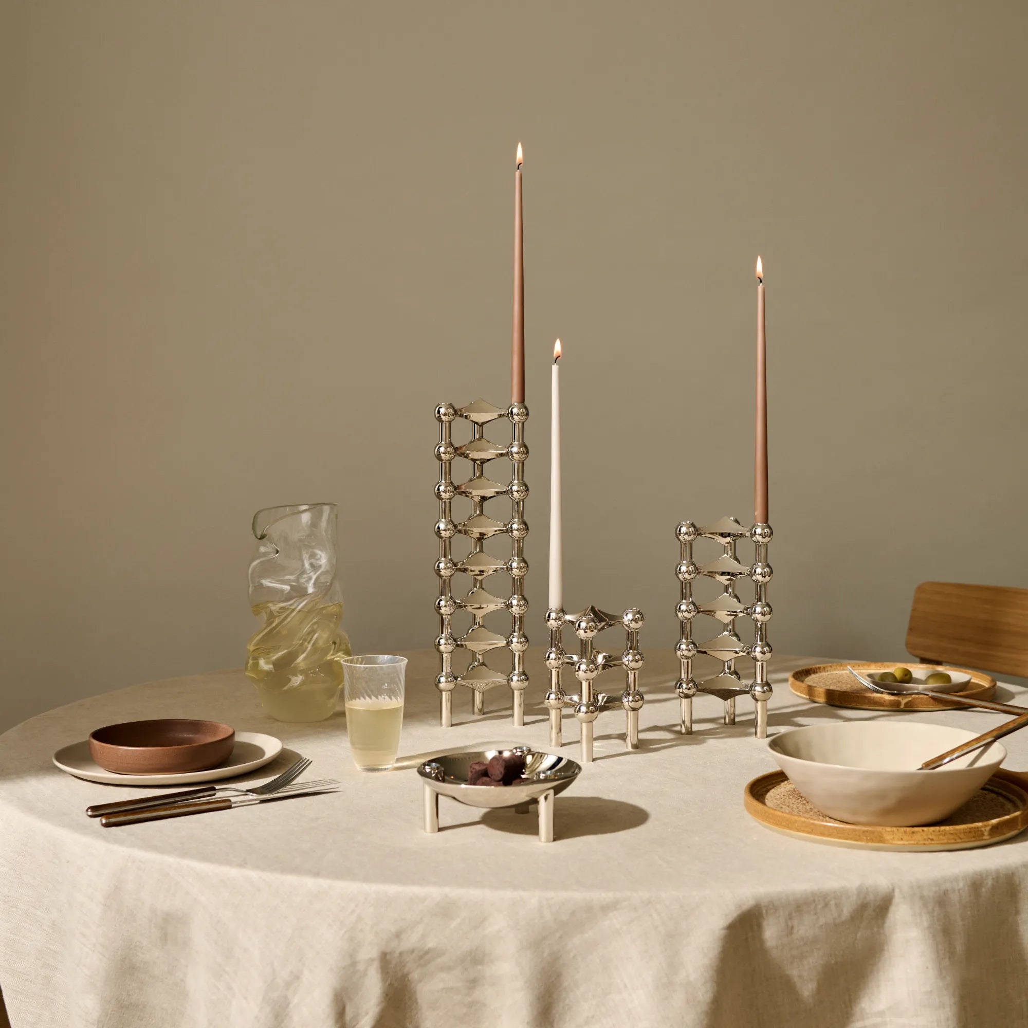 Sleek and contemporary candle holder with modular configuration and chrome finish