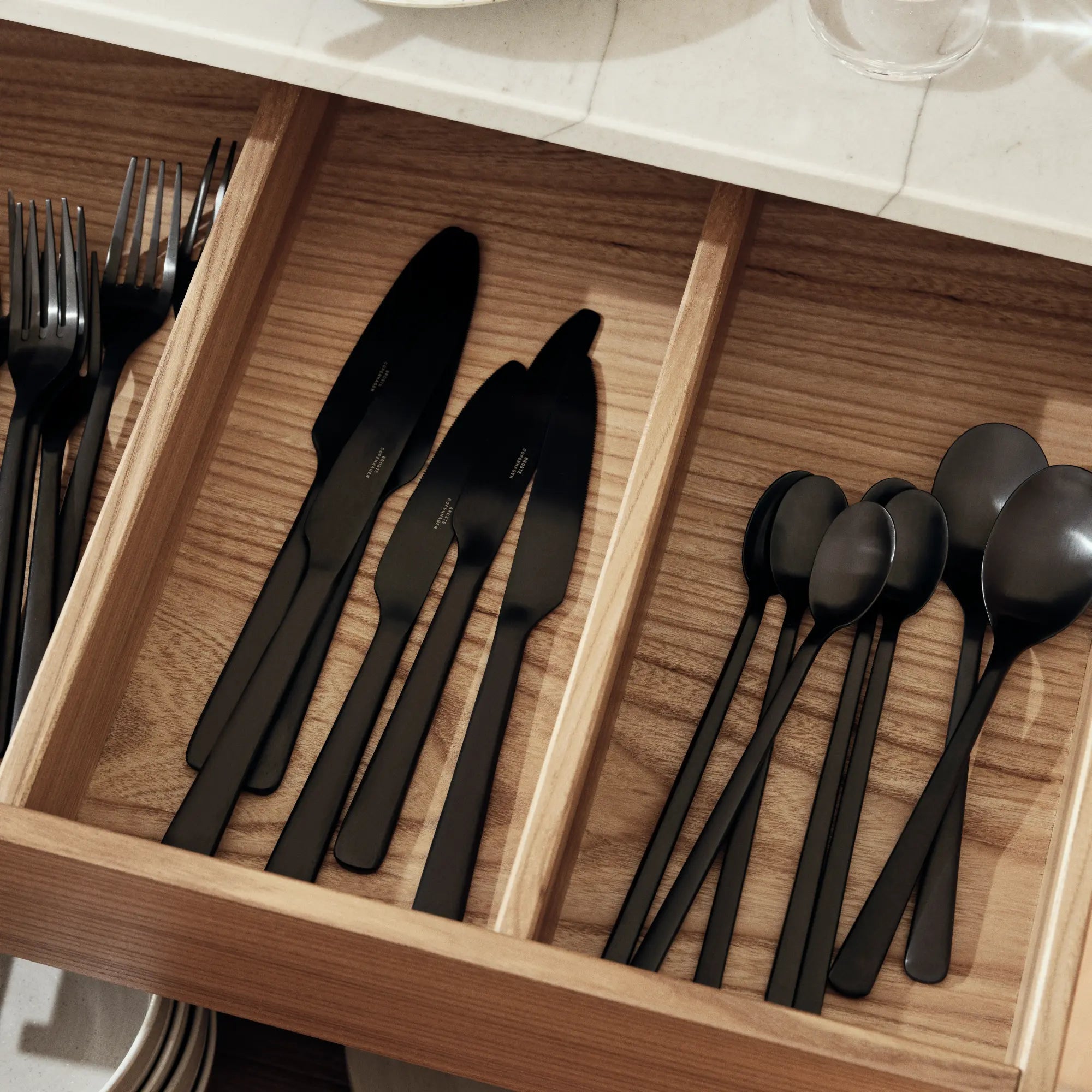 Stainless steel Hune Cutlery Set with sleek black handles and knife block