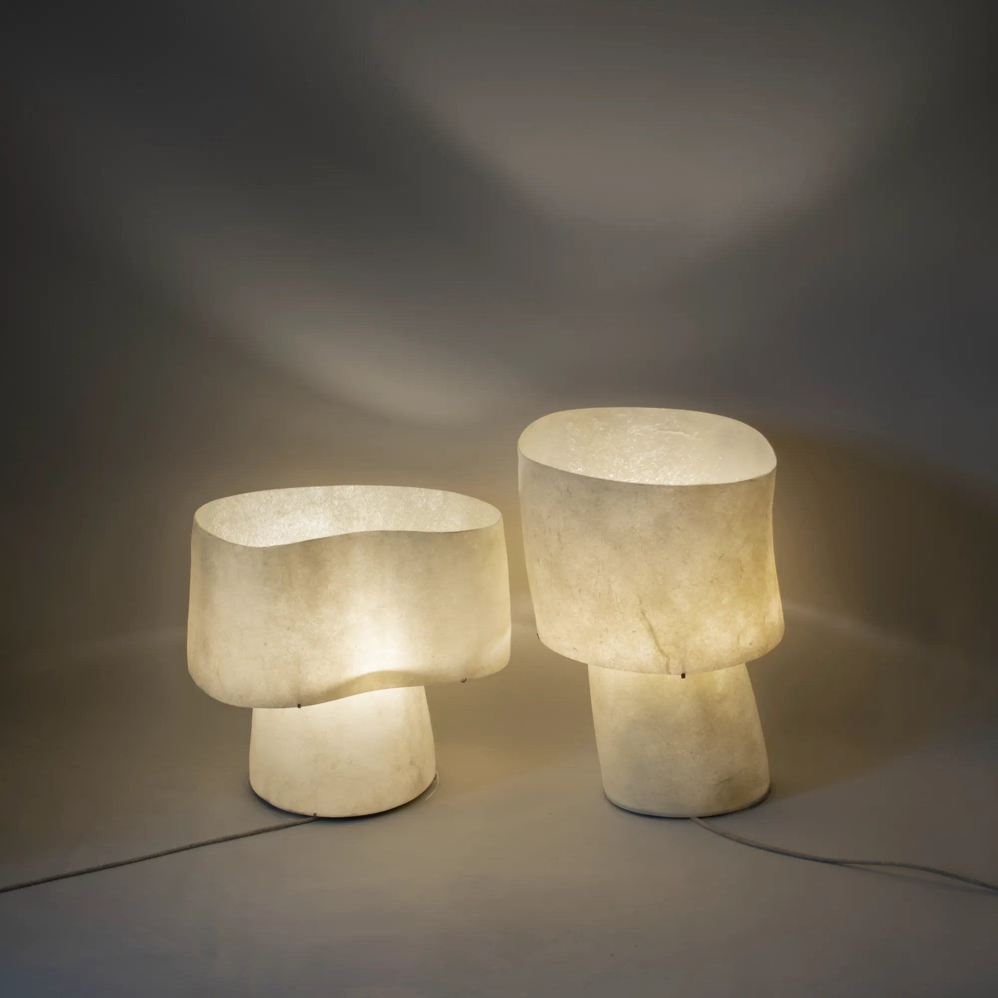 The “Mush” Lamp (Chub) emitting warm, ambient light in a modern office space