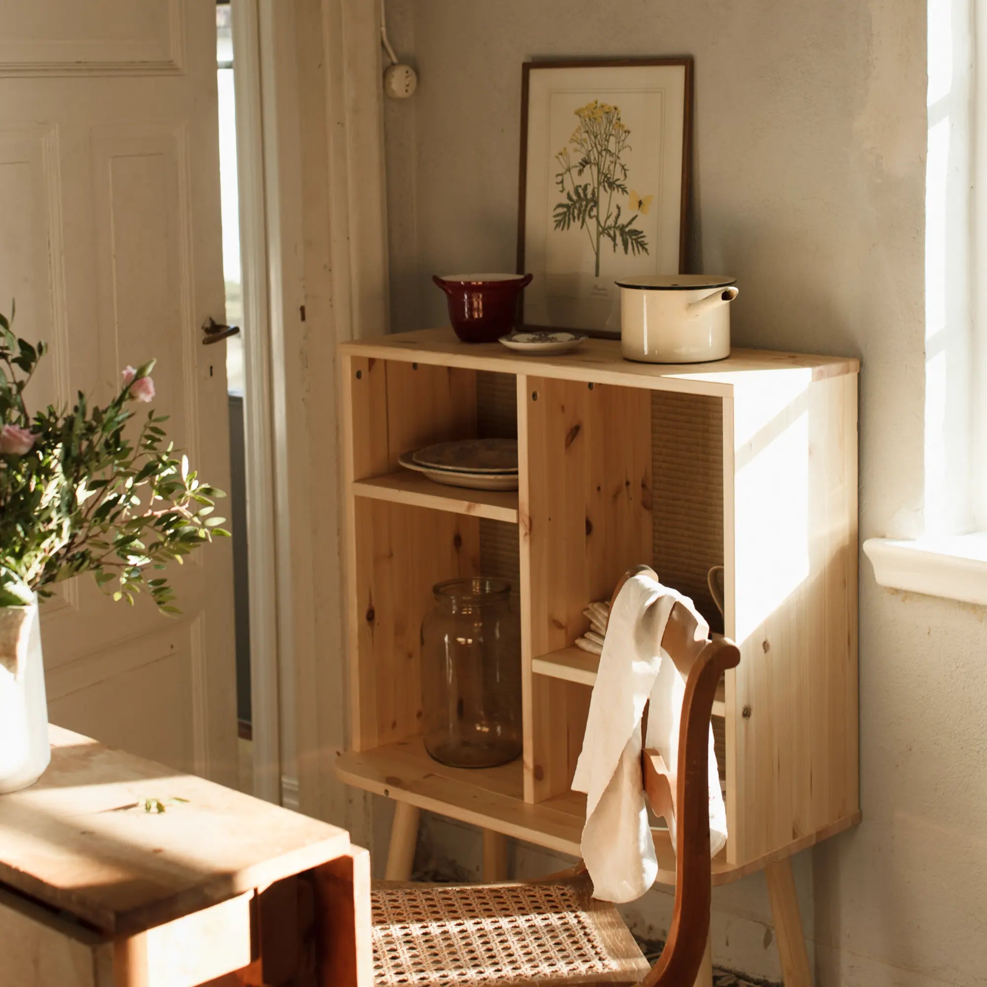 Kyabi Cabinet showcasing a rustic look with distressed wood and unique knobs