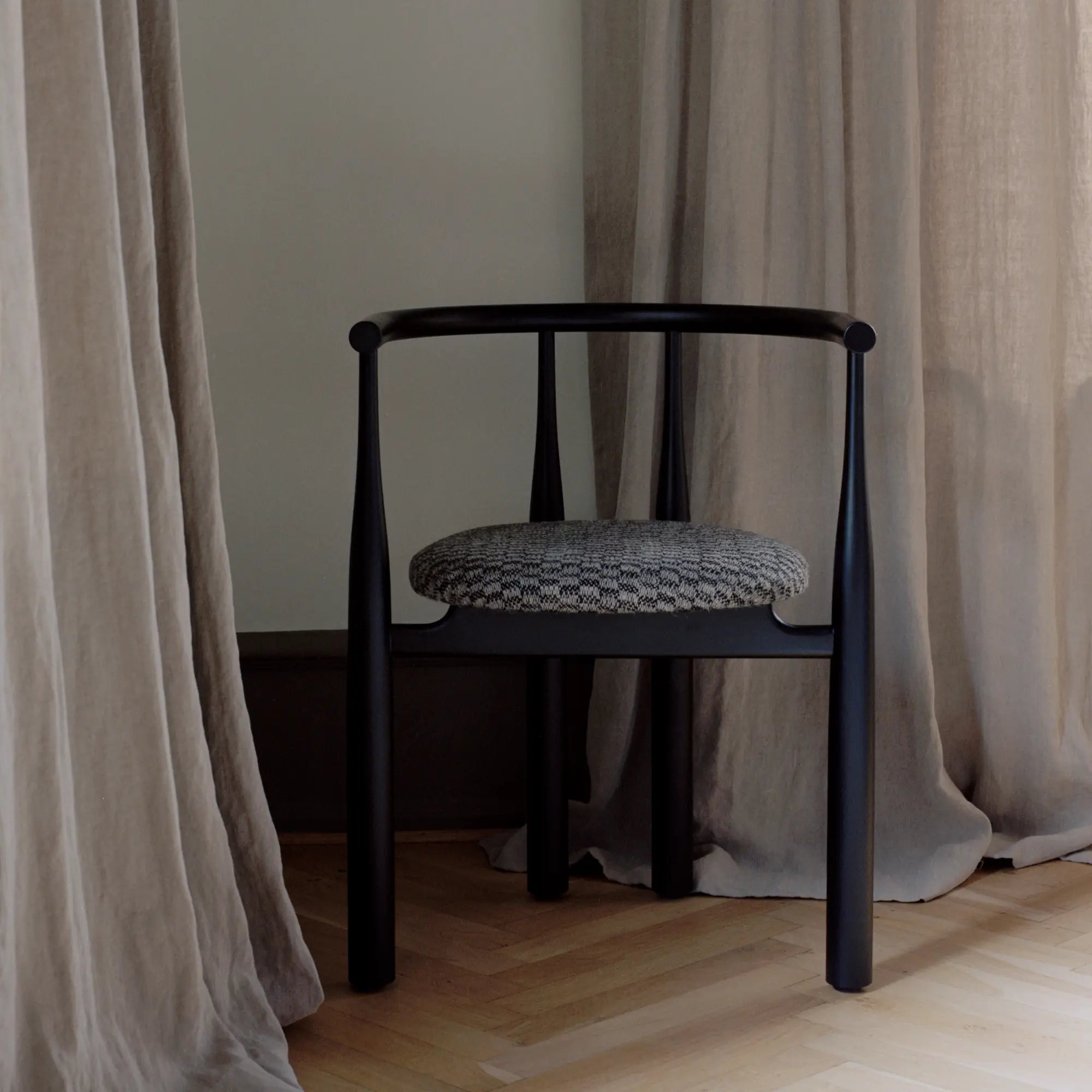 Sleek Bukowski Chair with polished chrome frame and black leather seat