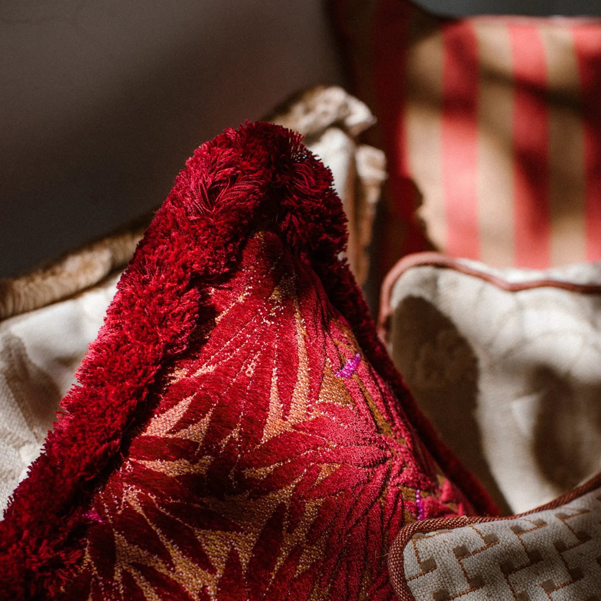 Yoko Bolster Pillow in magenta, adds a touch of luxury to your seating area