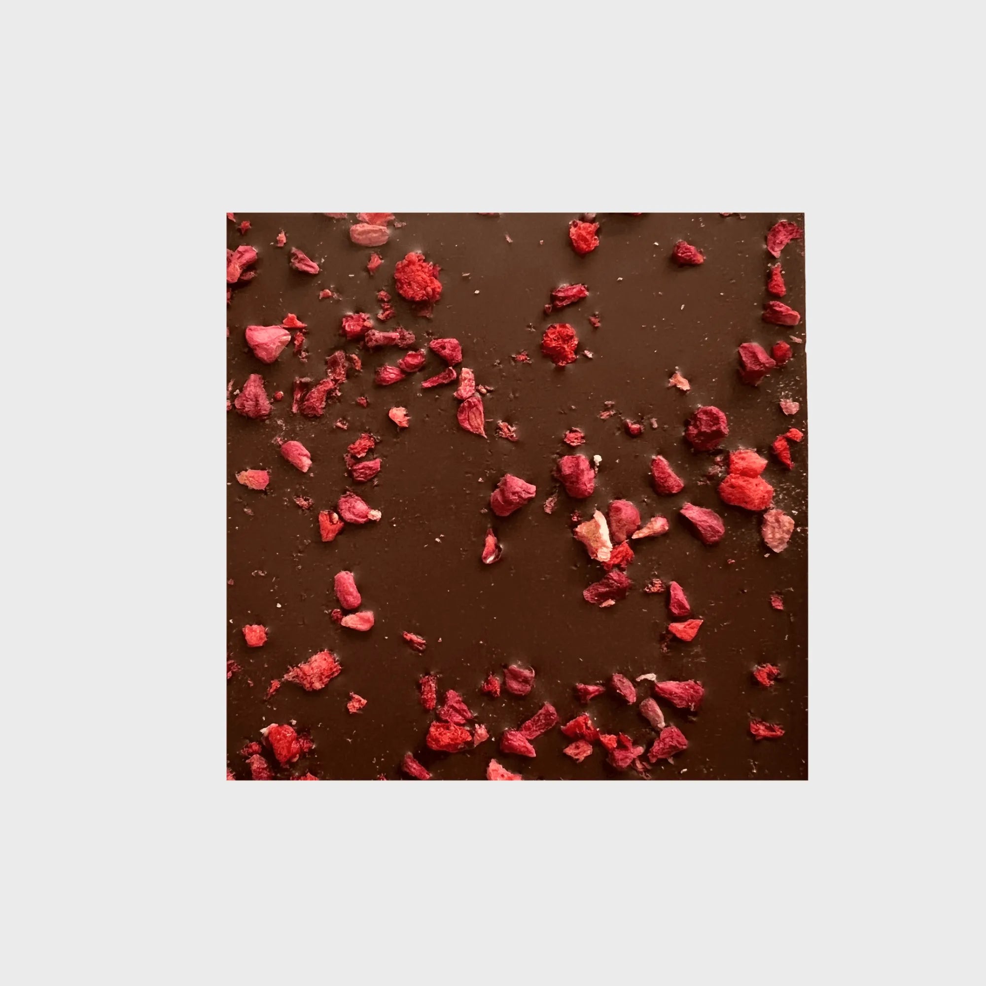 Delicious dark chocolate with 49% cacao topped with vibrant red berries