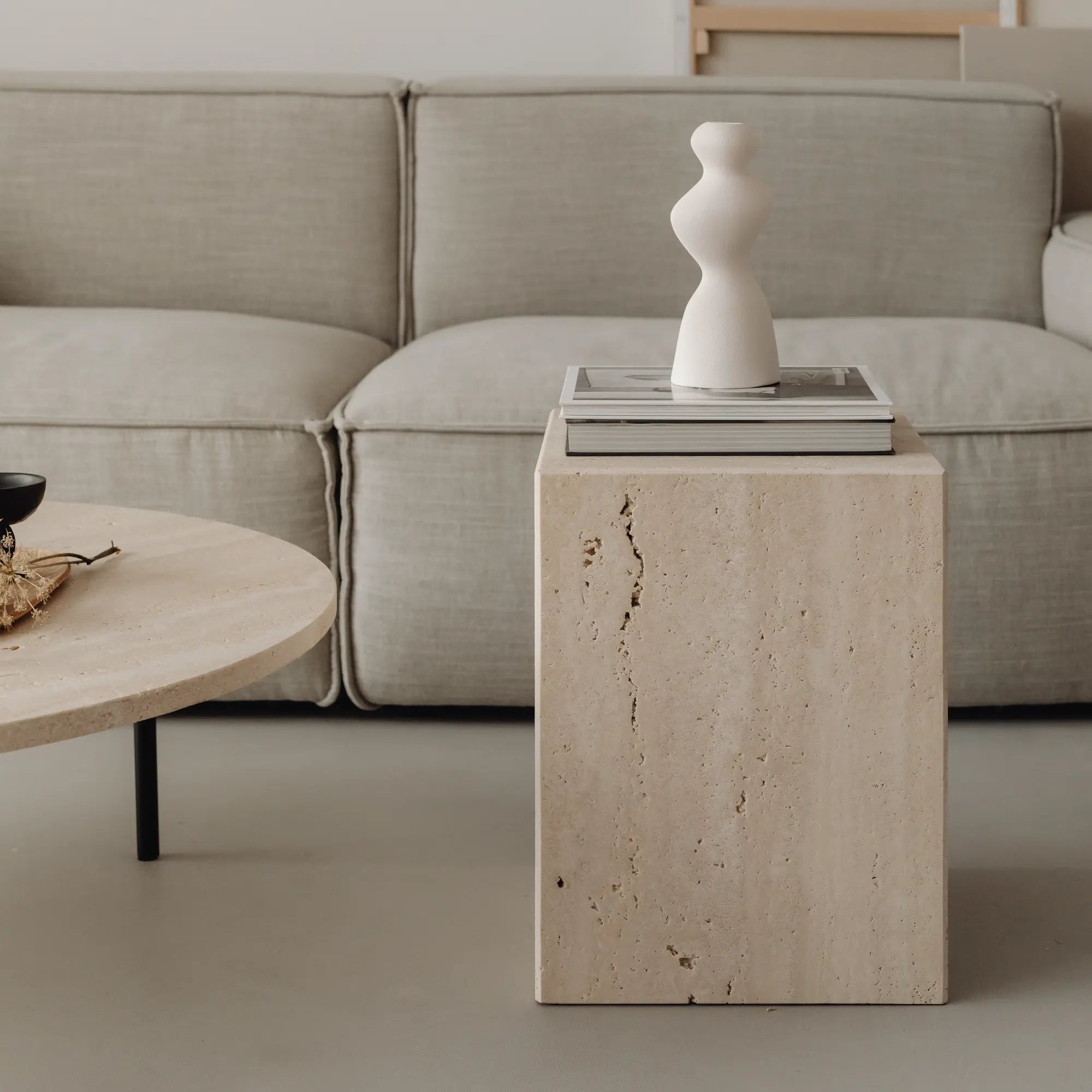 Coi Travertine Pillar standing tall in a modern interior design